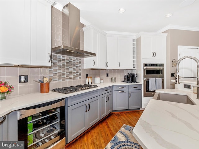 2503 Island Grove Blvd, Frederick, MD 21701 - kitchen with wall chimney range hood, beverage cooler, appliances with stainless steel finishes, gray cabinetry, and light wood-style floors