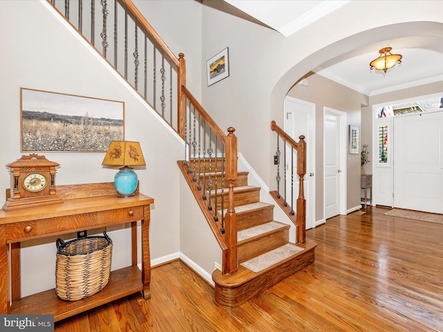 2503 Island Grove Blvd, Frederick, MD 21701 - entryway featuring arched walkways, crown molding, wood finished floors, and stairs