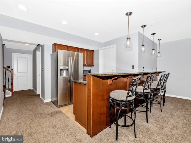2503 Island Grove Blvd, Frederick, MD 21701 - kitchen featuring stainless steel fridge with ice dispenser, brown cabinetry, light colored carpet, dark stone counters, and recessed lighting