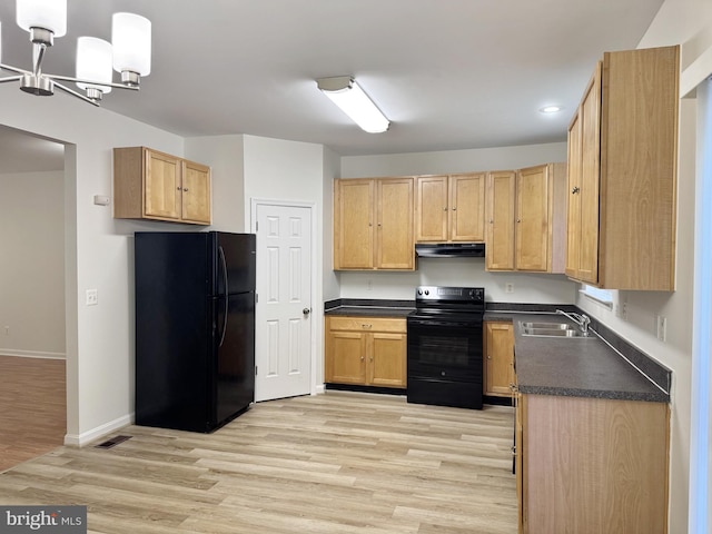 466 Sequoia Dr, Smyrna, DE 19977 - kitchen featuring black appliances, dark countertops, under cabinet range hood, light wood-type flooring, and a chandelier