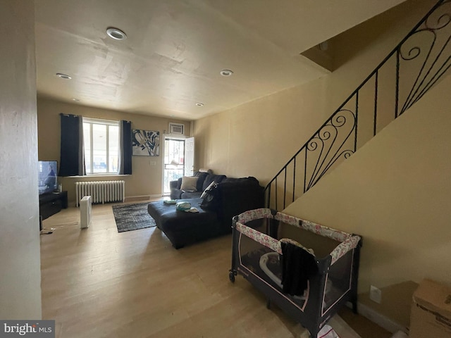 3102 N Taylor St, Philadelphia, PA 19132 - living area with radiator, wood finished floors, stairway, and recessed lighting