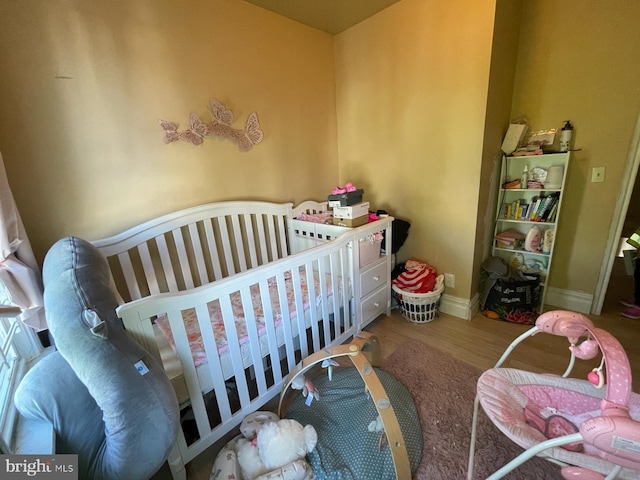 3102 N Taylor St, Philadelphia, PA 19132 - bedroom with wood finished floors and a crib