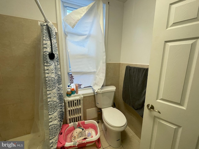 3102 N Taylor St, Philadelphia, PA 19132 - bathroom with a tile shower, tile walls, tile patterned floors, radiator heating unit, and a wainscoted wall