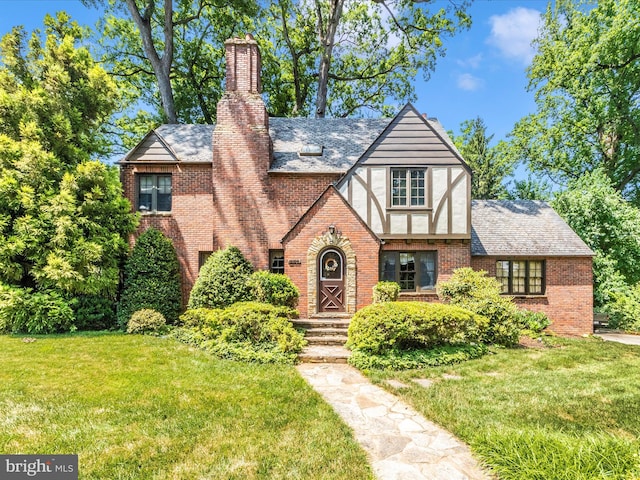 5100 Brook Green Rd, Baltimore, MD 21229 - tudor-style house featuring a front lawn, brick siding, and a chimney