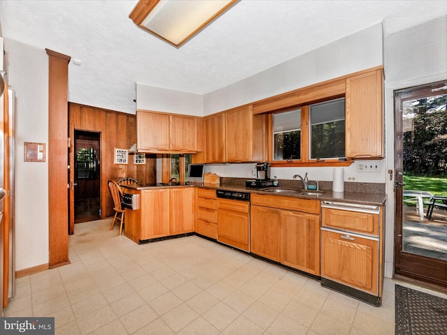 5100 Brook Green Rd, Baltimore, MD 21229 - kitchen with dishwasher, dark countertops, brown cabinets, wooden walls, and a textured ceiling