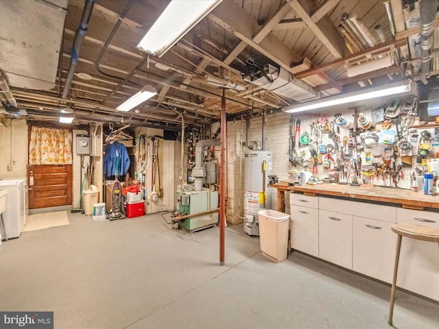 5100 Brook Green Rd, Baltimore, MD 21229 - unfinished below grade area with gas water heater, washer and dryer, a heating unit, and a workshop area