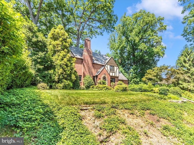 5100 Brook Green Rd, Baltimore, MD 21229 - view of front of house featuring a chimney and brick siding