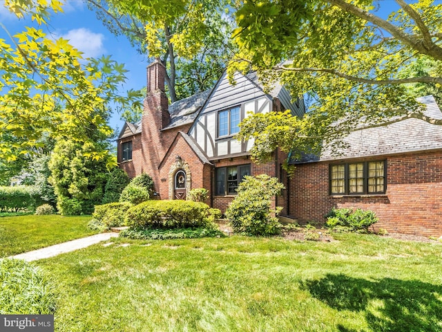 5100 Brook Green Rd, Baltimore, MD 21229 - english style home with brick siding, a chimney, and a front lawn