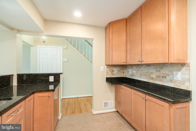 1906 Duffield Ln, Alexandria, VA 22307 - kitchen featuring decorative backsplash, dark stone countertops, light tile patterned floors, and recessed lighting