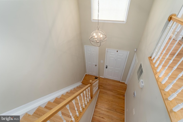 1906 Duffield Ln, Alexandria, VA 22307 - foyer entrance with a high ceiling, stairs, a chandelier, and light wood finished floors