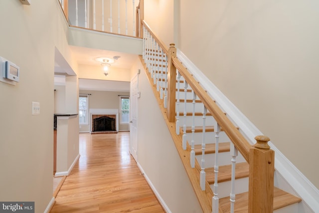 1906 Duffield Ln, Alexandria, VA 22307 - staircase with wood finished floors, a high ceiling, and a brick fireplace