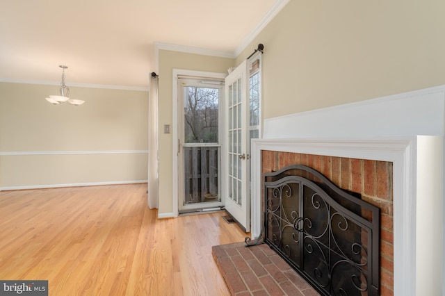 1906 Duffield Ln, Alexandria, VA 22307 - living area featuring wood finished floors, ornamental molding, a chandelier, and a brick fireplace
