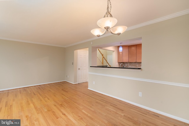 1906 Duffield Ln, Alexandria, VA 22307 - empty room with stairway, ornamental molding, light wood-style flooring, and a chandelier