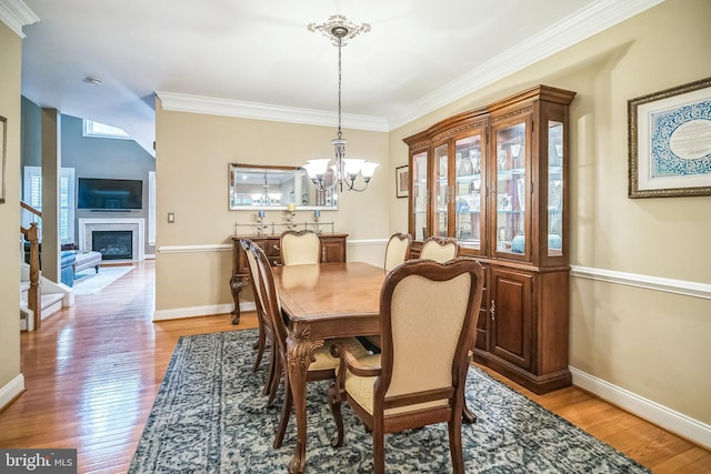 2350 Rosemont Ter, Furlong, PA 18925 - dining space with a chandelier, crown molding, light wood finished floors, and a glass covered fireplace