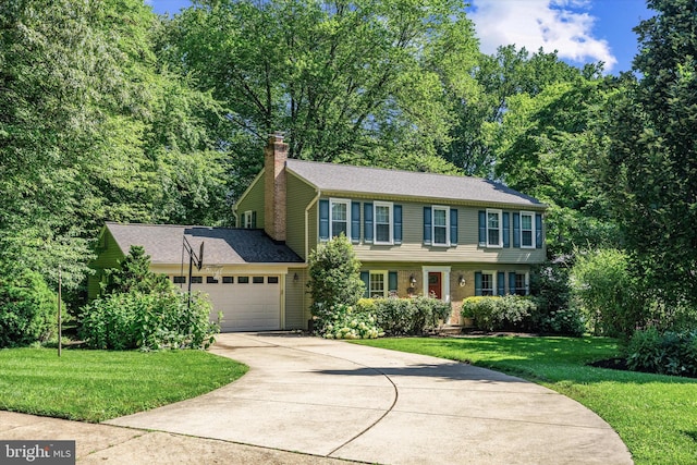 8614 Braeburn Dr, Annandale, VA 22003 - colonial home with a chimney, driveway, a garage, and a front lawn