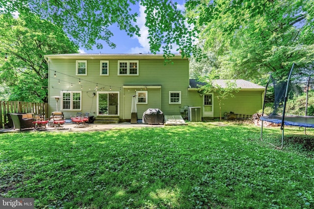 8614 Braeburn Dr, Annandale, VA 22003 - back of property with a trampoline, a patio area, and entry steps