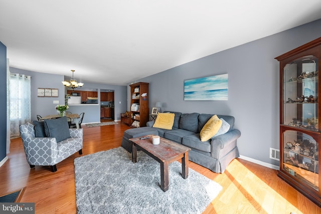 28 Powell Ct, Hightstown, NJ 08520 - living area with a chandelier and light wood-type flooring