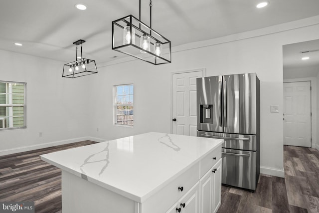 2305 James St, Baltimore, MD 21230 - kitchen featuring stainless steel refrigerator with ice dispenser, dark wood-style floors, white cabinets, recessed lighting, and hanging light fixtures
