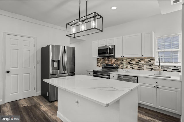 2305 James St, Baltimore, MD 21230 - kitchen with stainless steel appliances, dark wood-style floors, a kitchen island, backsplash, and recessed lighting