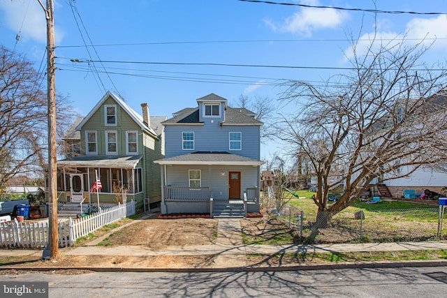 2305 James St, Baltimore, MD 21230 - view of front of home featuring covered porch, a shingled roof, and a fenced front yard