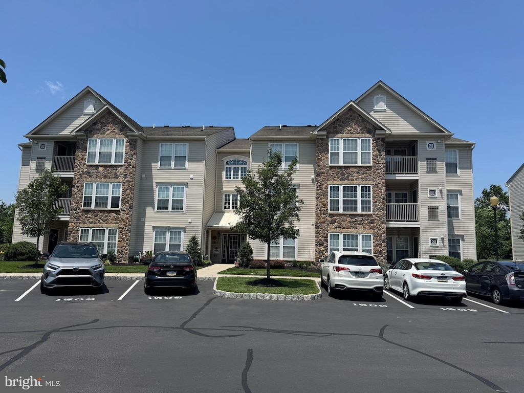 1509 Moore St Unit 302, Bristol, PA 19007 - view of building exterior featuring uncovered parking