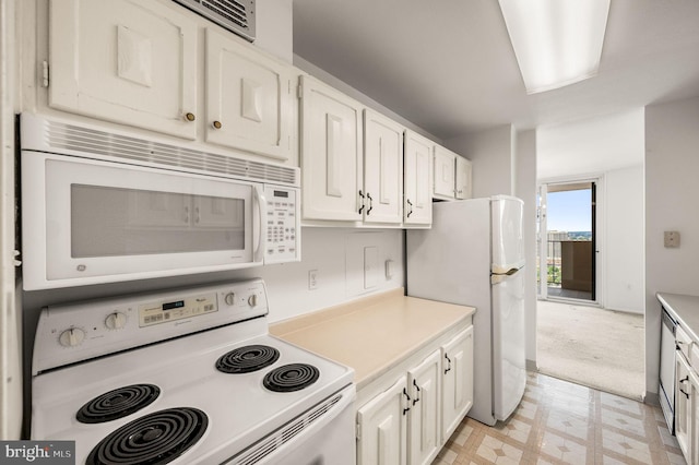 1901 John F Kennedy Blvd Unit 2923, Philadelphia, PA 19103 - kitchen featuring white appliances, light floors, light countertops, and white cabinetry