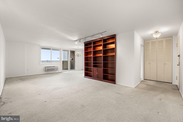 1901 John F Kennedy Blvd Unit 2923, Philadelphia, PA 19103 - unfurnished living room with a wall mounted air conditioner, a chandelier, rail lighting, and carpet flooring