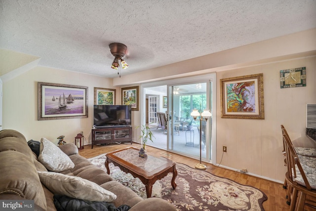12502 Kilbourne Ln, Bowie, MD 20715 - living room featuring a textured ceiling, a ceiling fan, and wood finished floors