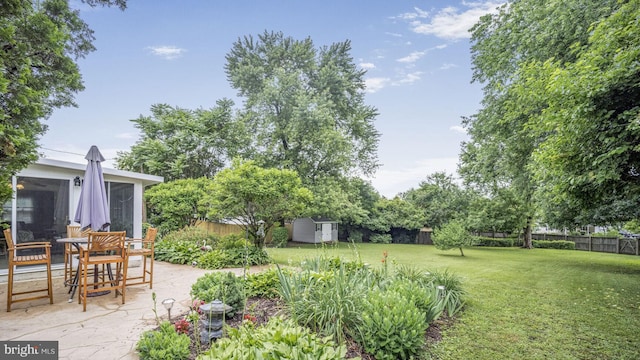 12502 Kilbourne Ln, Bowie, MD 20715 - fenced backyard featuring a storage shed, a patio, and a sunroom