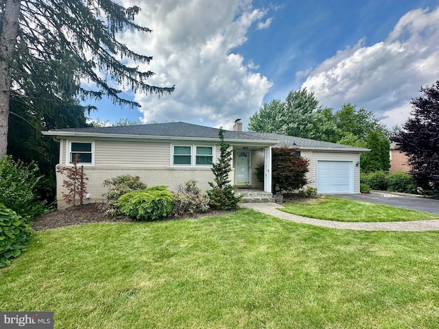 2475 Wharton Rd, York, PA 17402 - ranch-style house with driveway, an attached garage, brick siding, a chimney, and a front yard
