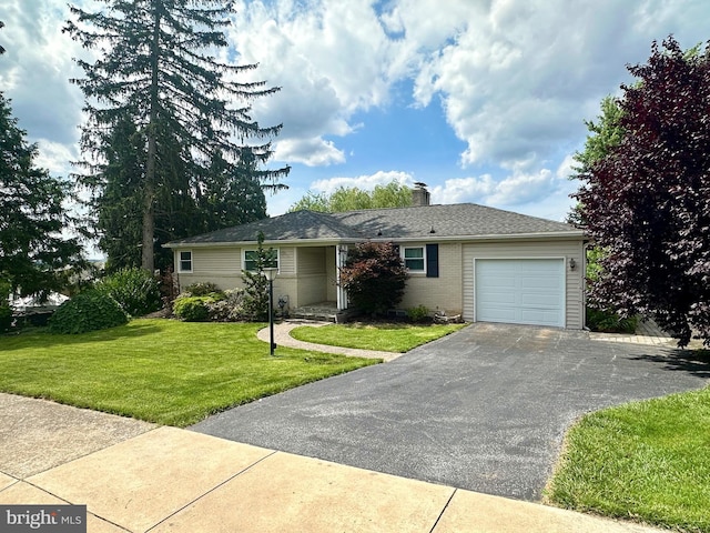 2475 Wharton Rd, York, PA 17402 - ranch-style home with an attached garage, asphalt driveway, a front lawn, and a chimney
