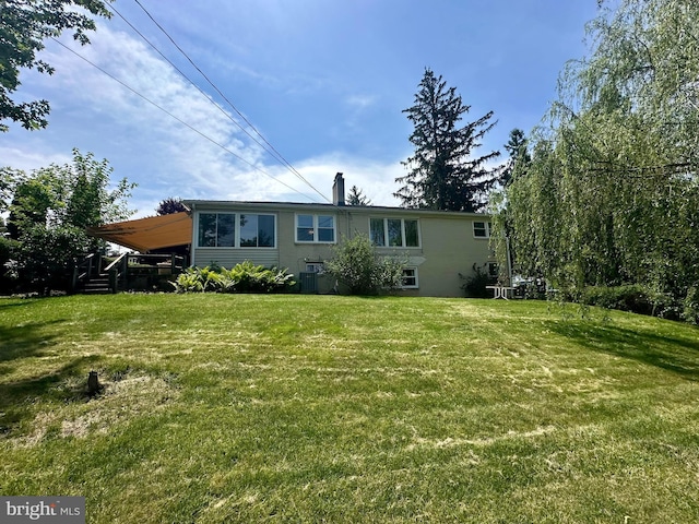 2475 Wharton Rd, York, PA 17402 - back of house featuring a yard and a chimney