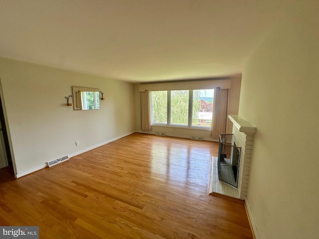 2475 Wharton Rd, York, PA 17402 - unfurnished living room featuring light wood-type flooring and a fireplace