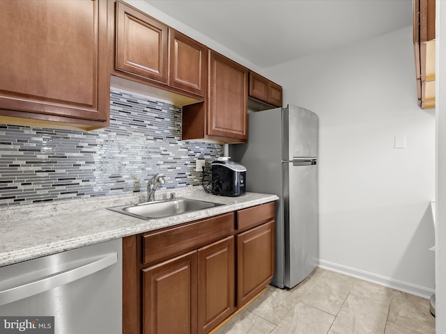 200 Erin Way Unit 204, Reisterstown, MD 21136 - kitchen featuring stainless steel appliances, backsplash, brown cabinets, and light tile patterned floors