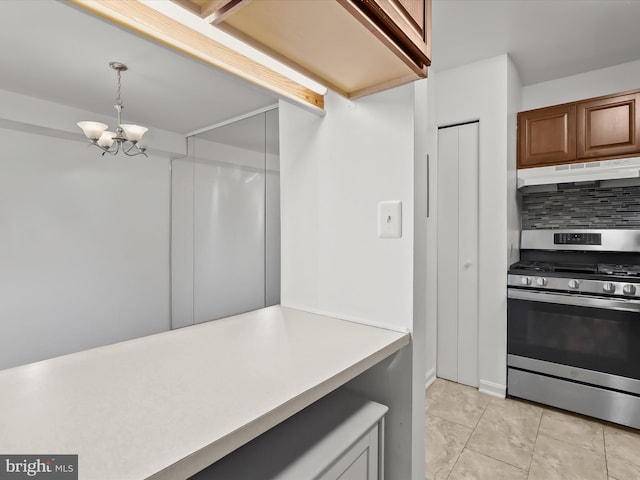 200 Erin Way Unit 204, Reisterstown, MD 21136 - kitchen with stainless steel range with gas stovetop, under cabinet range hood, a chandelier, tasteful backsplash, and light countertops