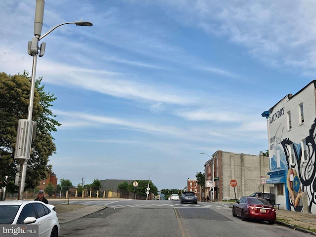 1405 Presstman St, Baltimore, MD 21217 - view of asphalt road featuring traffic signs, street lighting, sidewalks, and curbs