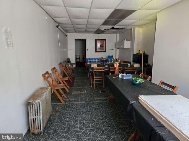 1405 Presstman St, Baltimore, MD 21217 - dining area with radiator heating unit, dark floors, and a paneled ceiling