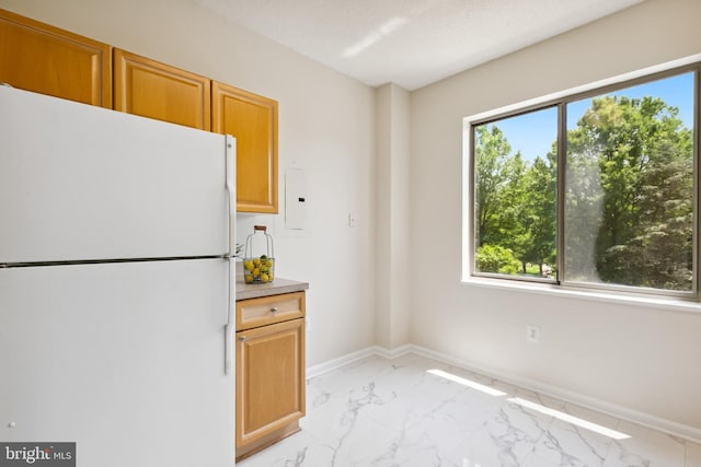 3005 S Leisure World Blvd Unit 226, Silver Spring, MD 20906 - kitchen with freestanding refrigerator, light marble finish floors, and light countertops