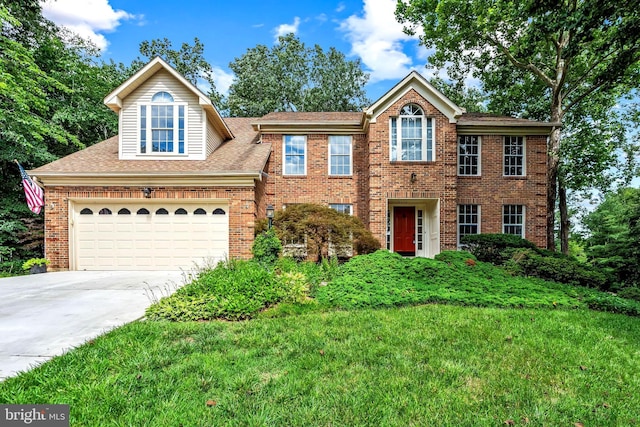 16715 Tintagel Ct, Dumfries, VA 22025 - view of front of home with brick siding, driveway, a garage, and roof with shingles
