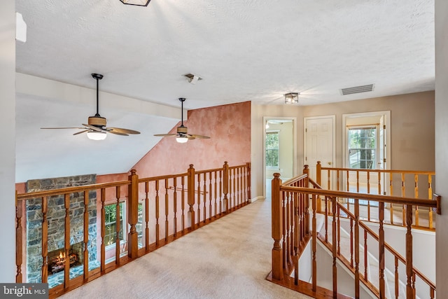 16715 Tintagel Ct, Dumfries, VA 22025 - hallway featuring an upstairs landing, a textured ceiling, carpet, and lofted ceiling