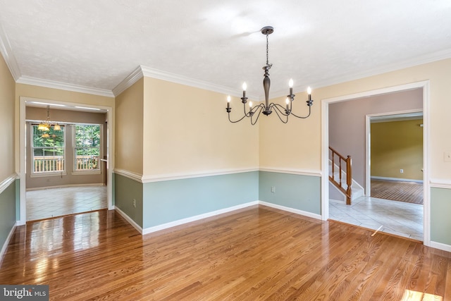 16715 Tintagel Ct, Dumfries, VA 22025 - unfurnished room featuring a chandelier, stairs, wood finished floors, and crown molding
