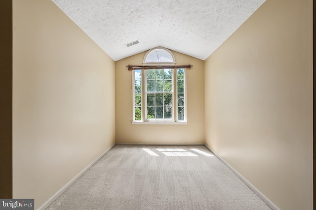 16715 Tintagel Ct, Dumfries, VA 22025 - carpeted empty room featuring a textured ceiling and lofted ceiling
