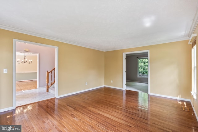 16715 Tintagel Ct, Dumfries, VA 22025 - unfurnished room with wood-type flooring, a chandelier, crown molding, and stairs