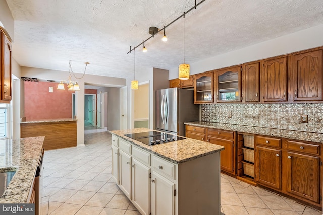 16715 Tintagel Ct, Dumfries, VA 22025 - kitchen with freestanding refrigerator, black electric cooktop, light tile patterned flooring, a textured ceiling, and tasteful backsplash
