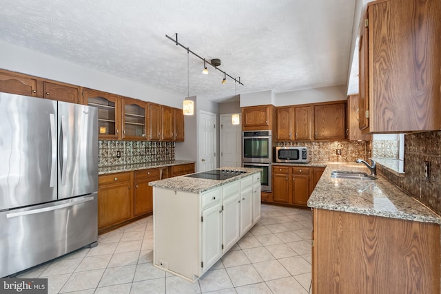 16715 Tintagel Ct, Dumfries, VA 22025 - kitchen with stainless steel appliances, brown cabinetry, a center island, tasteful backsplash, and a textured ceiling