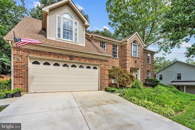 16715 Tintagel Ct, Dumfries, VA 22025 - traditional home with brick siding, concrete driveway, roof with shingles, and an attached garage
