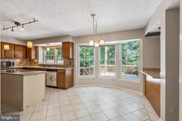 16715 Tintagel Ct, Dumfries, VA 22025 - kitchen with dishwasher, backsplash, brown cabinets, stainless steel microwave, and a textured ceiling