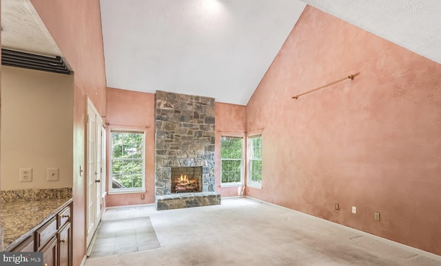 16715 Tintagel Ct, Dumfries, VA 22025 - unfurnished living room featuring plenty of natural light, high vaulted ceiling, carpet floors, and a fireplace