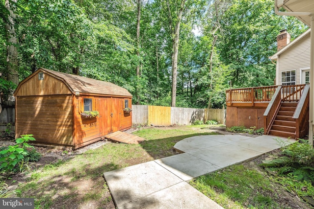 16715 Tintagel Ct, Dumfries, VA 22025 - fenced backyard featuring a storage shed, a wooden deck, a patio, and stairs