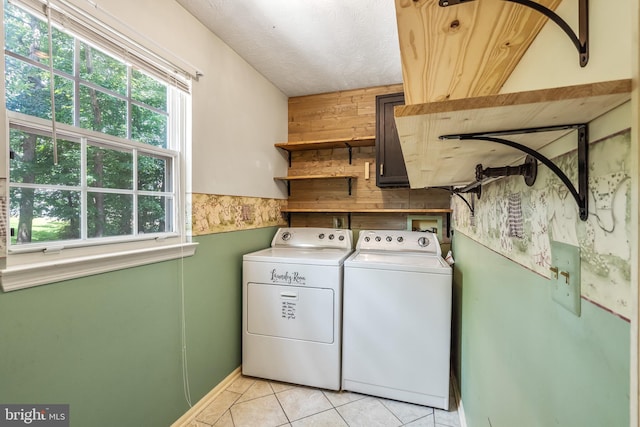 16715 Tintagel Ct, Dumfries, VA 22025 - laundry room featuring washer and dryer, plenty of natural light, and light tile patterned floors